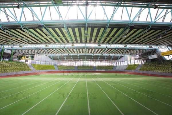Extensive sports hall with green running track, surrounded by large windows, Sindelfingen Glass