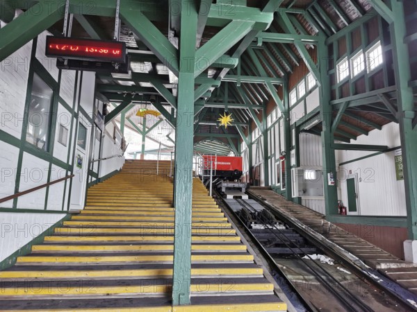 Large mountain station in wooden design with yellow stairs leads to the cable car, Oberweissbach