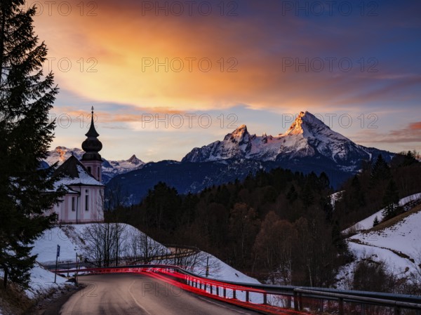 Watzmann and the pilgrimage church of Maria Gern at dawn, traces of light on the road in the