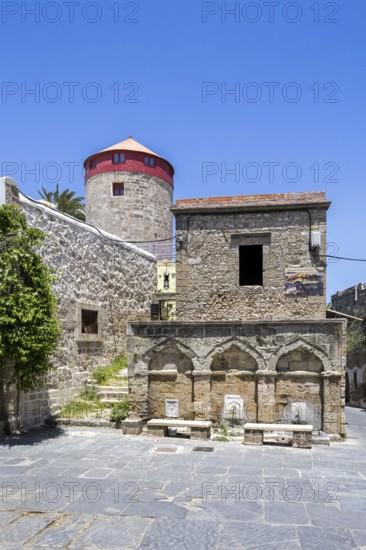 Ottoman fountain and windmill in the historic old town from the Middle Ages on the island of