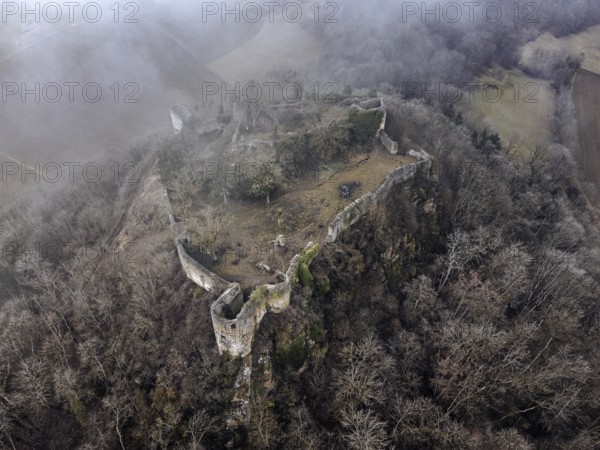 Aerial view of the ruins of Mägdeberg Castle in Hegau on a foggy winter day, Mühlhausen-Ehingen,