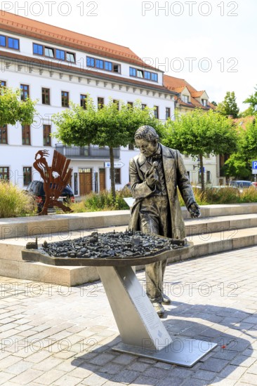 Silver figure explorer traveling by Ekaterina Kovalenko on Castle Square with bronze model of the