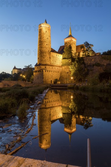 Old water art and St. Michael's Church are reflected in the Spree, night view, Bautzen, Saxony,