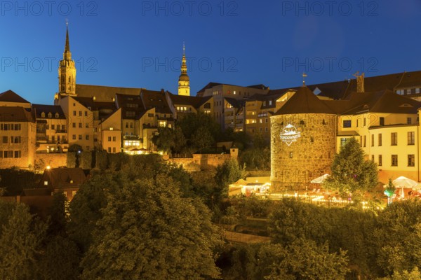 City view at night with St. Petri Cathedral, Town Hall Tower and Röhrscheidtbastei with beer