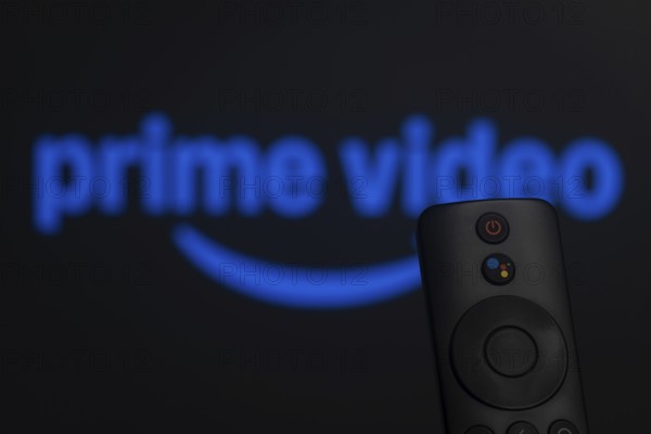 Dhaka, Bangladesh- 21 Jan 2026: Close-up of a smart TV remote control against a blurred Amazon