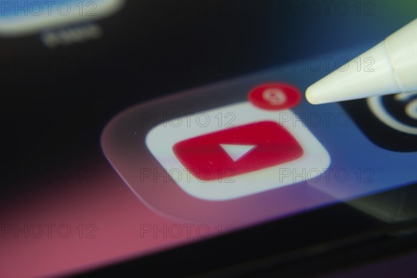 16 Nov 2025- Dhaka, Bangladesh: Stylus touching the youtube app icon with a notification on a