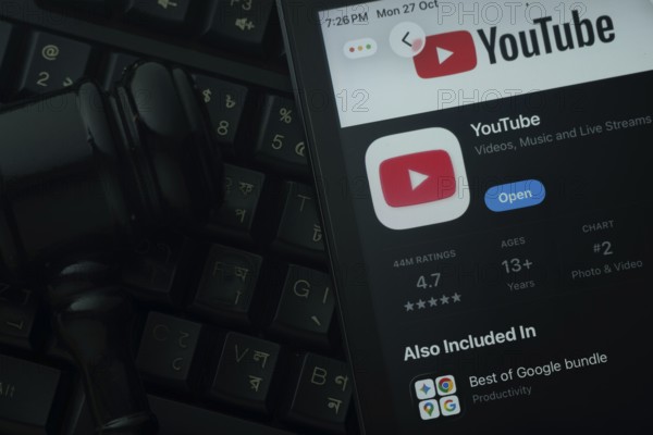 Dhaka, Bangladesh- 28 Oct 2025: An iPad displaying the youtube app against a judge's gavel and dark