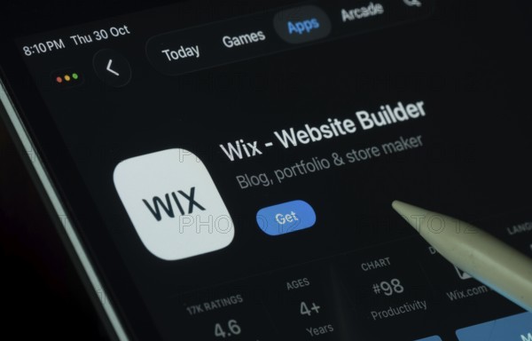 Dhaka, Bangladesh- 30 Oct 2025: Wix app displayed on a iPad screen in dark mode with a digital pen