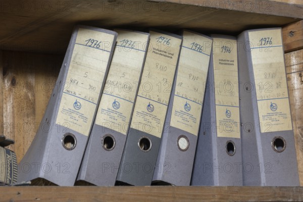 Shelves with dusty folders in the administration of a former GDR factory, Lost Place,