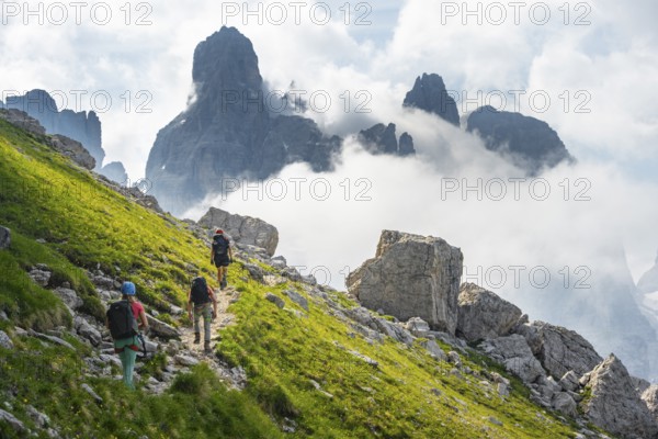 Climbers on a hiking trail, rocky mountain landscape with fog, Via Ferrata SOSAT via ferrata,