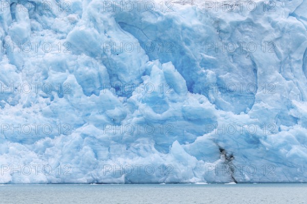 Blue ice wall of Idabreen, Ida glacier calving into Liefdefjorden at Idabukta bay, Haakon VII Land,