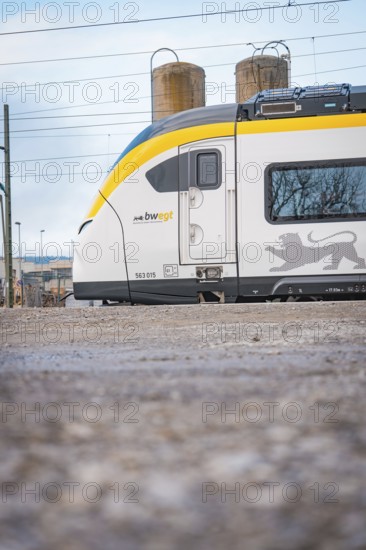 Partial view of a modern locomotive next to industrial structures, opening of the Hermann Hesse