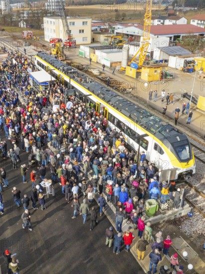 Assembly of people at a construction site event with a train, opening of the Hermann Hesse Railway,