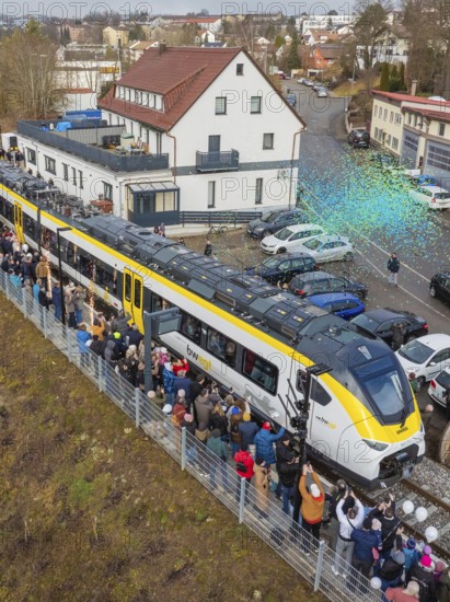 Train surrounded by a crowd in an urban area, aerial view, opening of the Hermann Hesse Railway,