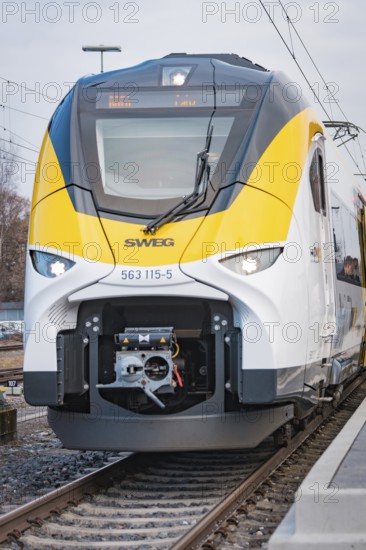 Close-up of the modern front of a white train with yellow elements, opening of the Hermann Hesse