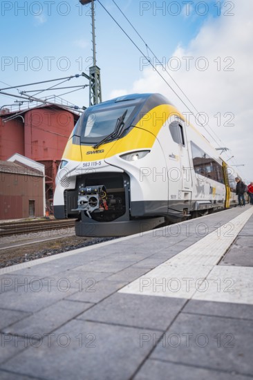 A modern train with a yellow front is on the platform, opening of the Hermann Hesse Railway, Calw,