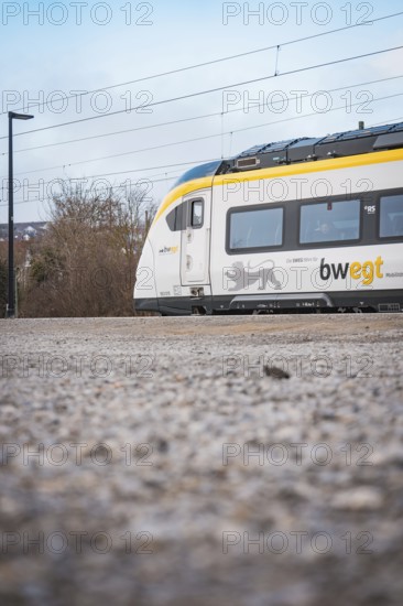 Side view of a modern train surrounded by a wintry atmosphere, opening of the Hermann Hesse