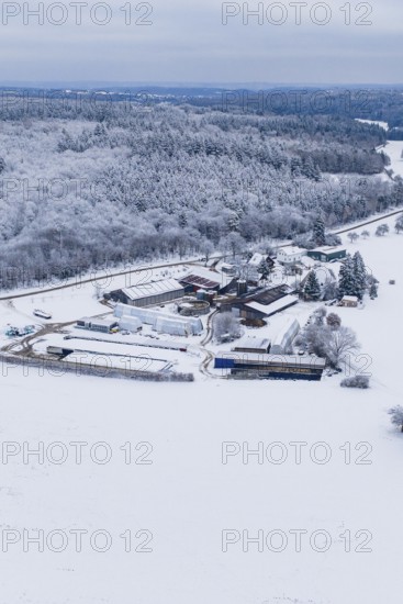 Snowy landscape with farm surrounded by forests and fields under grey skies, Haselstaller Hof,