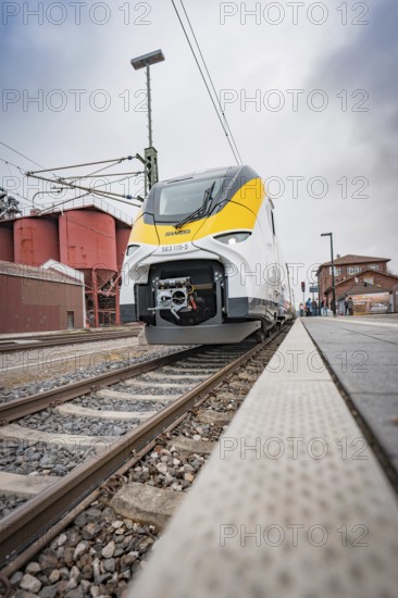 Train in the distance on the tracks heading to the platform, battery electric train Siemens Micro