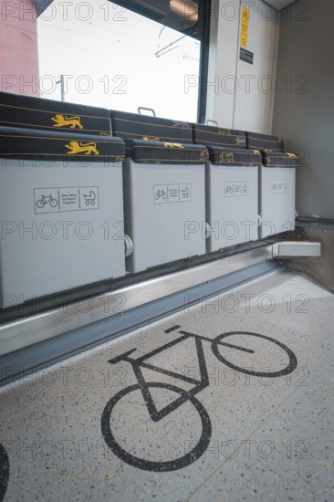 Detailed view of a bicycle parking space in a train compartment with folding seats, battery