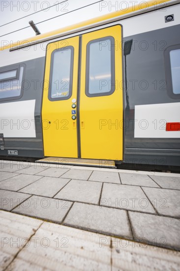 Close-up of a yellow train door on a platform, Siemens Micro Plus B battery electric train,