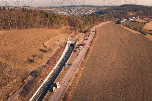 Tunnel with emergency vehicles and barriers along the road taken from the air, fire drill on the