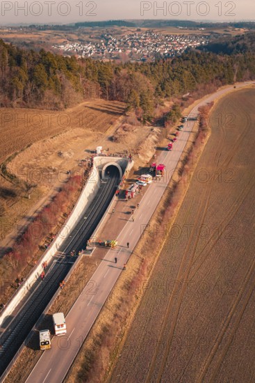 Aerial view of a tunnel with emergency vehicles and barriers along the road, fire drill on the