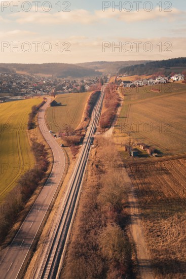 Aerial view of a rural area with railroad, road and village in the background, fire drill on the