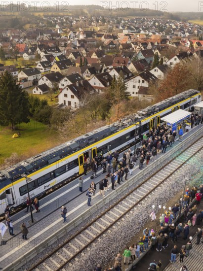 Train in rural areas stops along the platform with numerous observers, opening of the Hermann Hesse