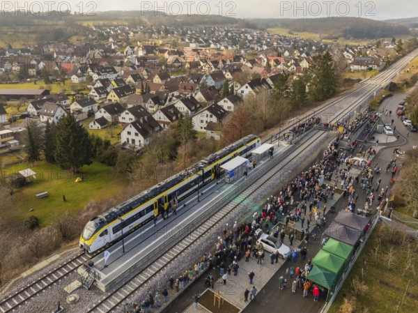 Village event on the arrival of a train, people gather at the platform, opening of the Hermann