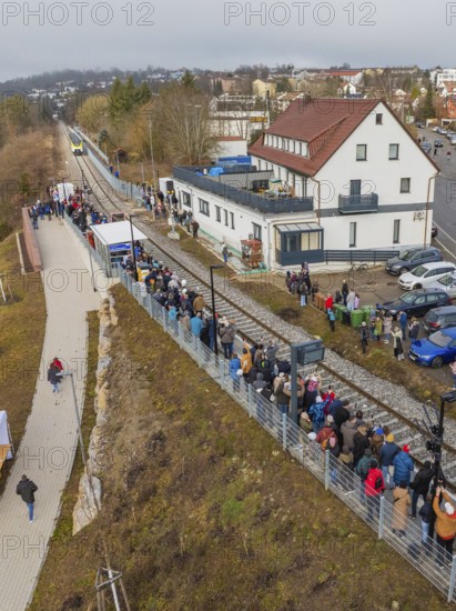 Numerous people lining up along the tracks in a village, opening of the Hermann Hesse Railway,