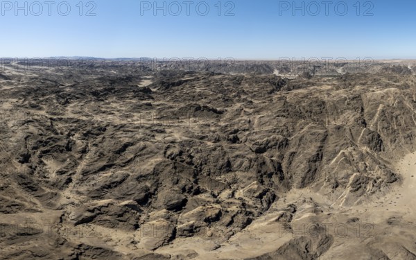 Aerial view, dry barren mountains in Moon Valley, rocky landscape ridged by erosion, Namib-Naukluft