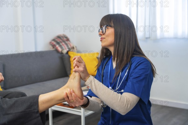 Healthcare professional wearing blue scrubs and a stethoscope examining an elderly patient's foot