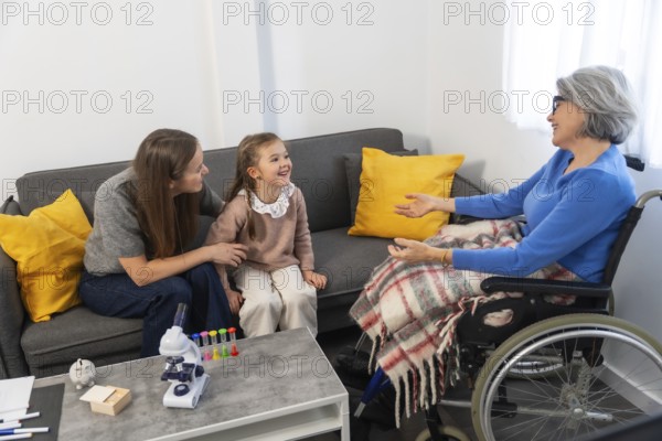 Three generations of family members warmly interacting, an elderly woman in a wheelchair engaging