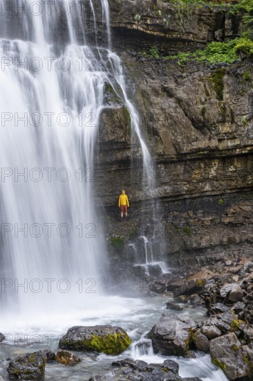 Adventure, Little hiker under large Cascata di Mezzo waterfall, long exposure, Vallesinella,