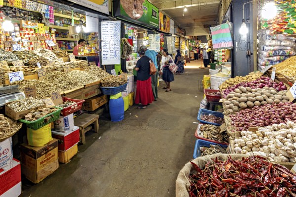 Bustling marketplace full of spices and vegetables with people in narrow corridors, The old market