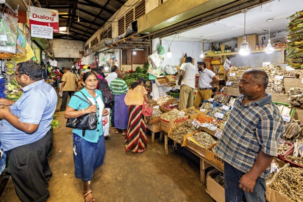 Lively marketplace with people looking at herbs and local produce, The ancient market halls of