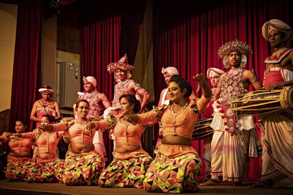 Dancers in colorful, traditional costumes dance with drummers on a stage, folklore and dancers from