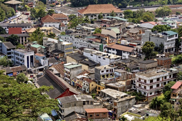 City view with densely built houses, green surroundings and various architectural styles, view of