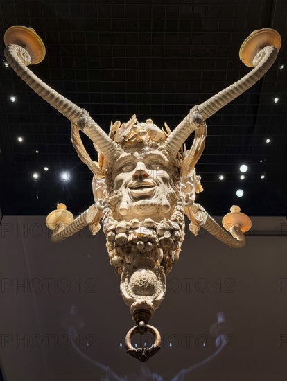 Ivory candle holder with intricate carving of a face, ivory collection, Bavarian National Museum,