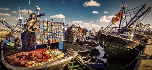 Colourful fishing boats in the harbor with numerous nets and ropes under clear skies, vivid colors,