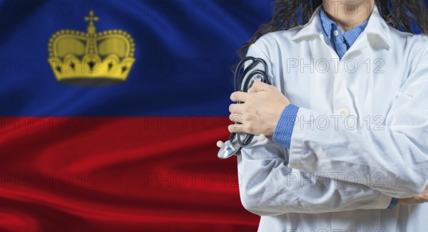 Healthcare professional with Liechtenstein flag background. Professional doctor holding stethoscope
