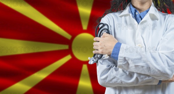 Healthcare professional with North Macedonia flag background. Professional doctor holding