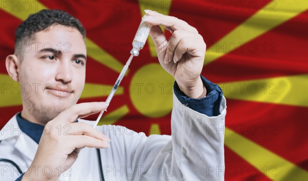Doctor holding syringe on North Macedonia flag background. Medical professional holding syringe