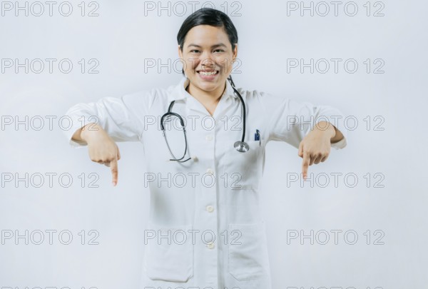 Young asian female doctor recommending an advertisement. Asian female doctor pointing at medical