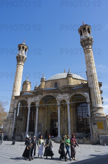 Historic mosque with distinctive minarets and people on the square in front of it, Aziziye Mosque,