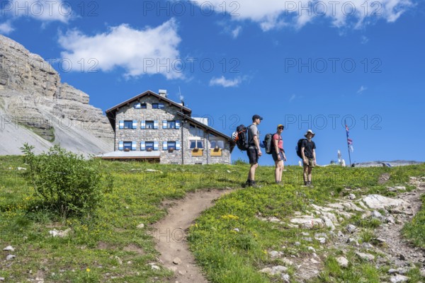 Hikers in front of Rifugio Graffer, Brenta, Brenta-Adamello Natural Park, Trentino, Italy