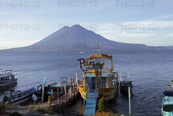 Boats on the dock, Lake Atitlán or Lake Atitlán in the morning, the volcanoes Atitlán and Toliman