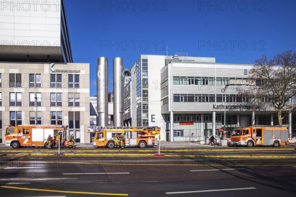 Fire service at Stuttgart Hospital. Fire trucks are parked in front of the building following a