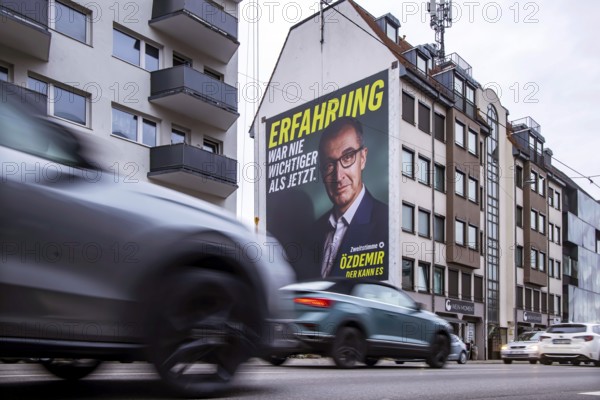 Mega poster on a house pediment. Cem Özdemir, leading candidate of the Green Party. 2026 state